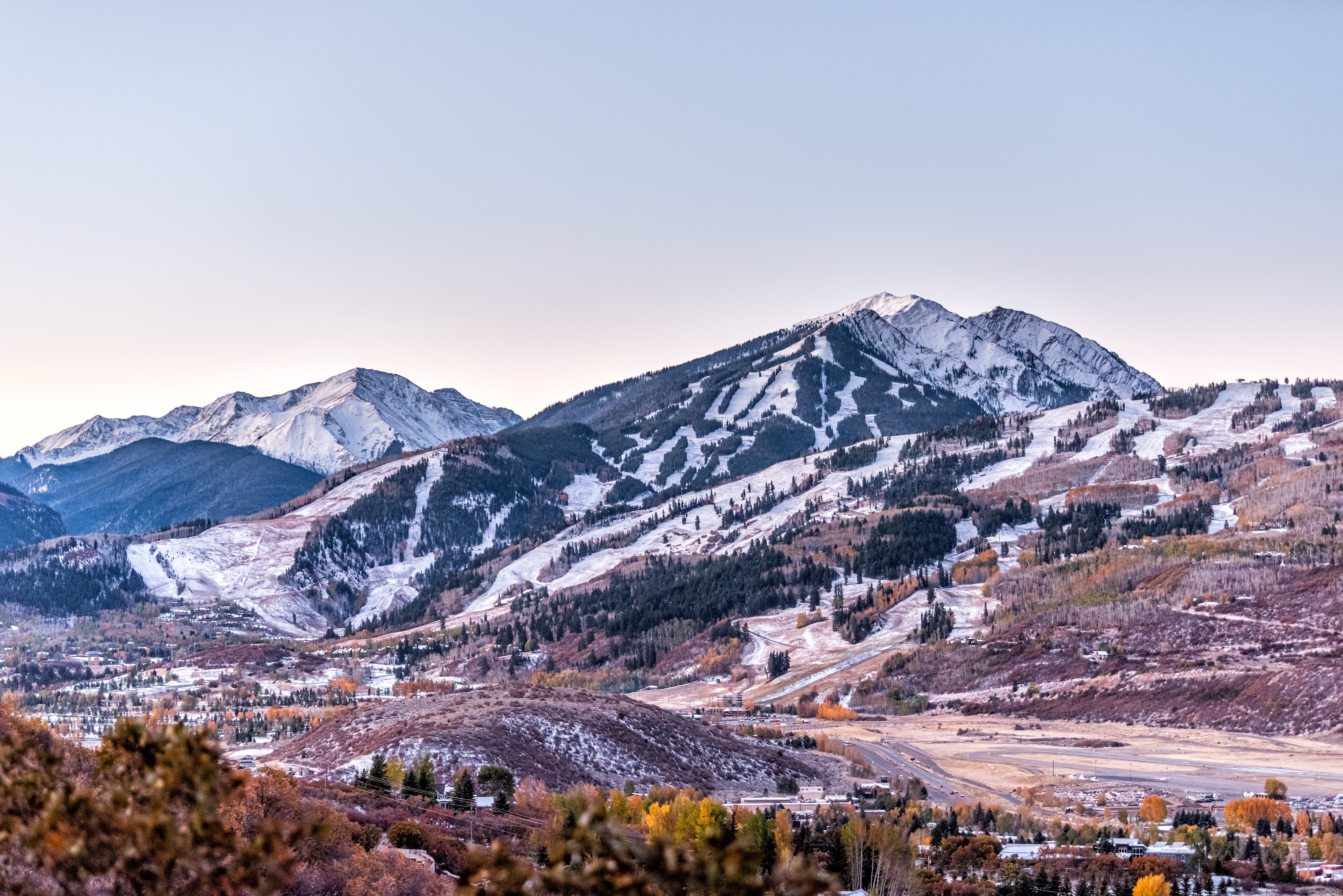 Aspen/Pitkin County Airport with surrounding Rocky Mountains and ski slopes in winter