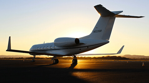 business jet on the ramp at sunset