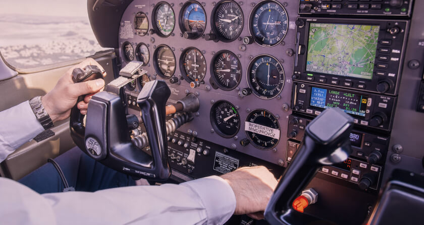 pilot in the cockpit at dusk