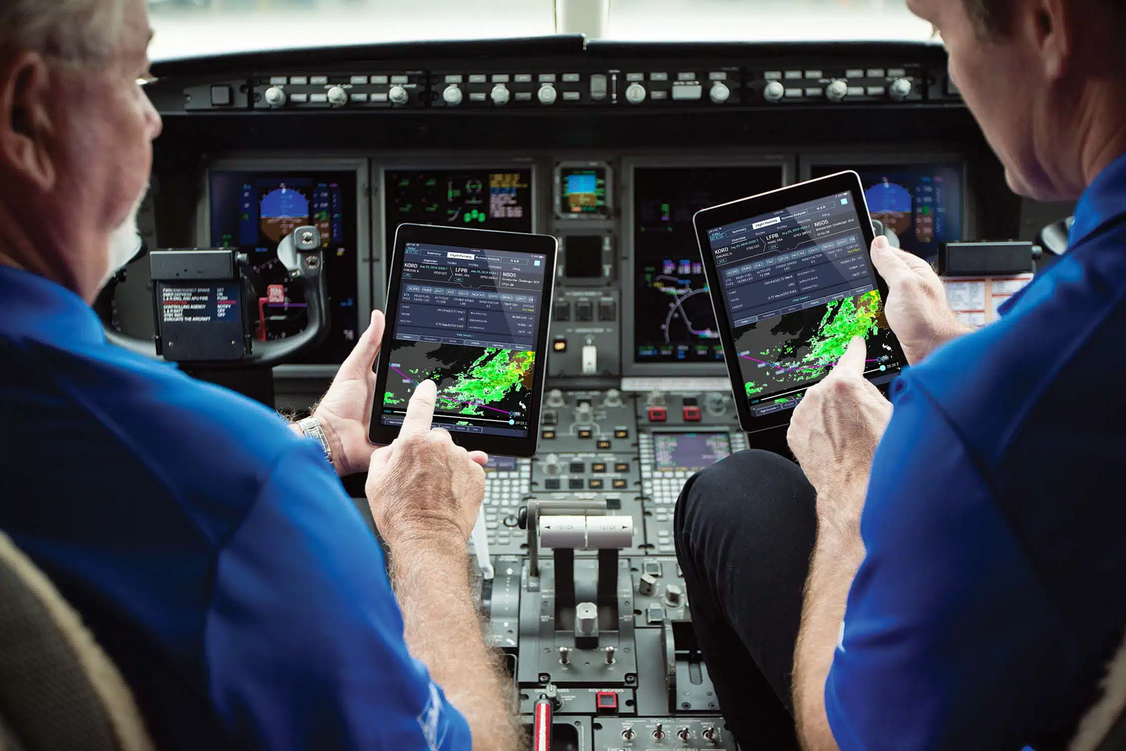 Business aviation pilots using a flight planning app to review weather on flight path